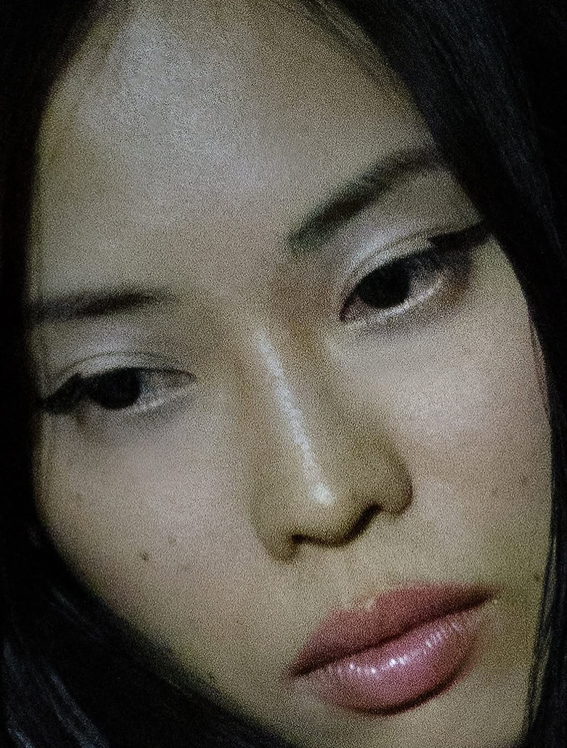 Close up of a female model with natural makeup and wing liner.